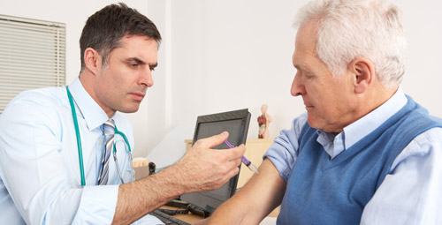 A doctor giving an older man a vaccination